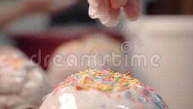特写的复活节蛋糕洒满了洒水。 库存录像。 在甜美的白色釉面蛋糕上倒彩虹